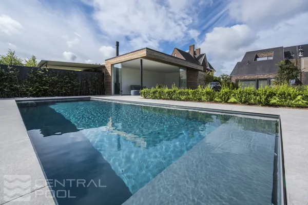 Modern pool with paved surround